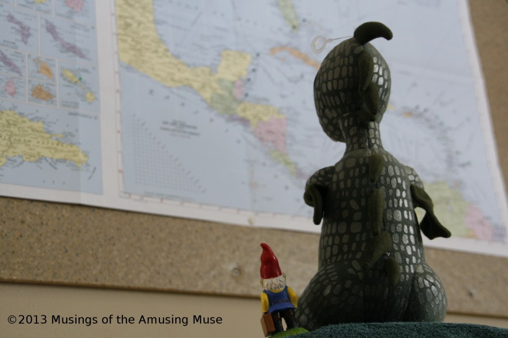 Charlie the Chupacabra and Cedric the Roaming Gnome studying the Caribbean map.